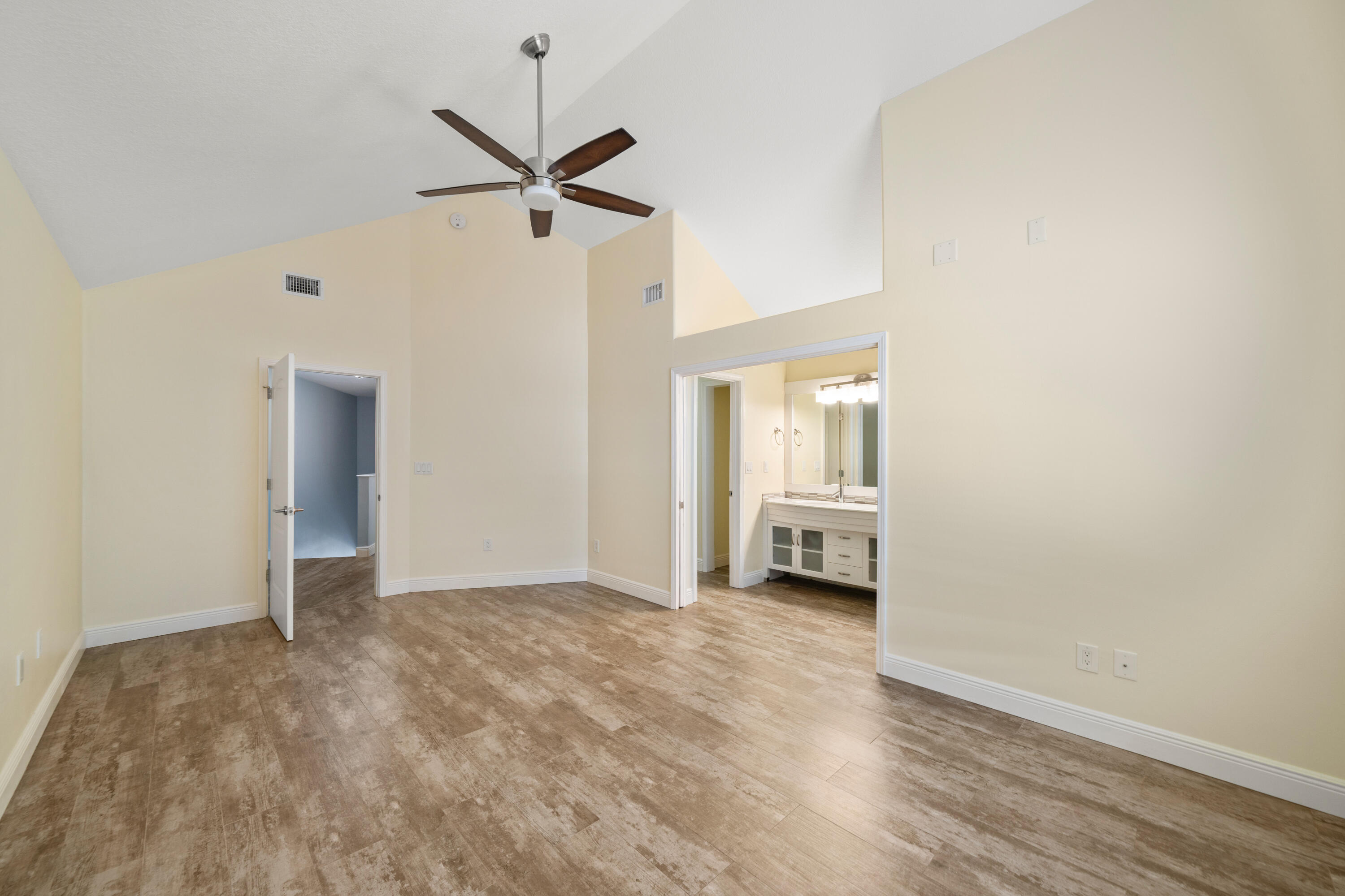 235 Pelican Place, Unit 3 Destin, FL 32541 - Photo 13 of 32 a view of empty room with wooden floor and ceiling fan