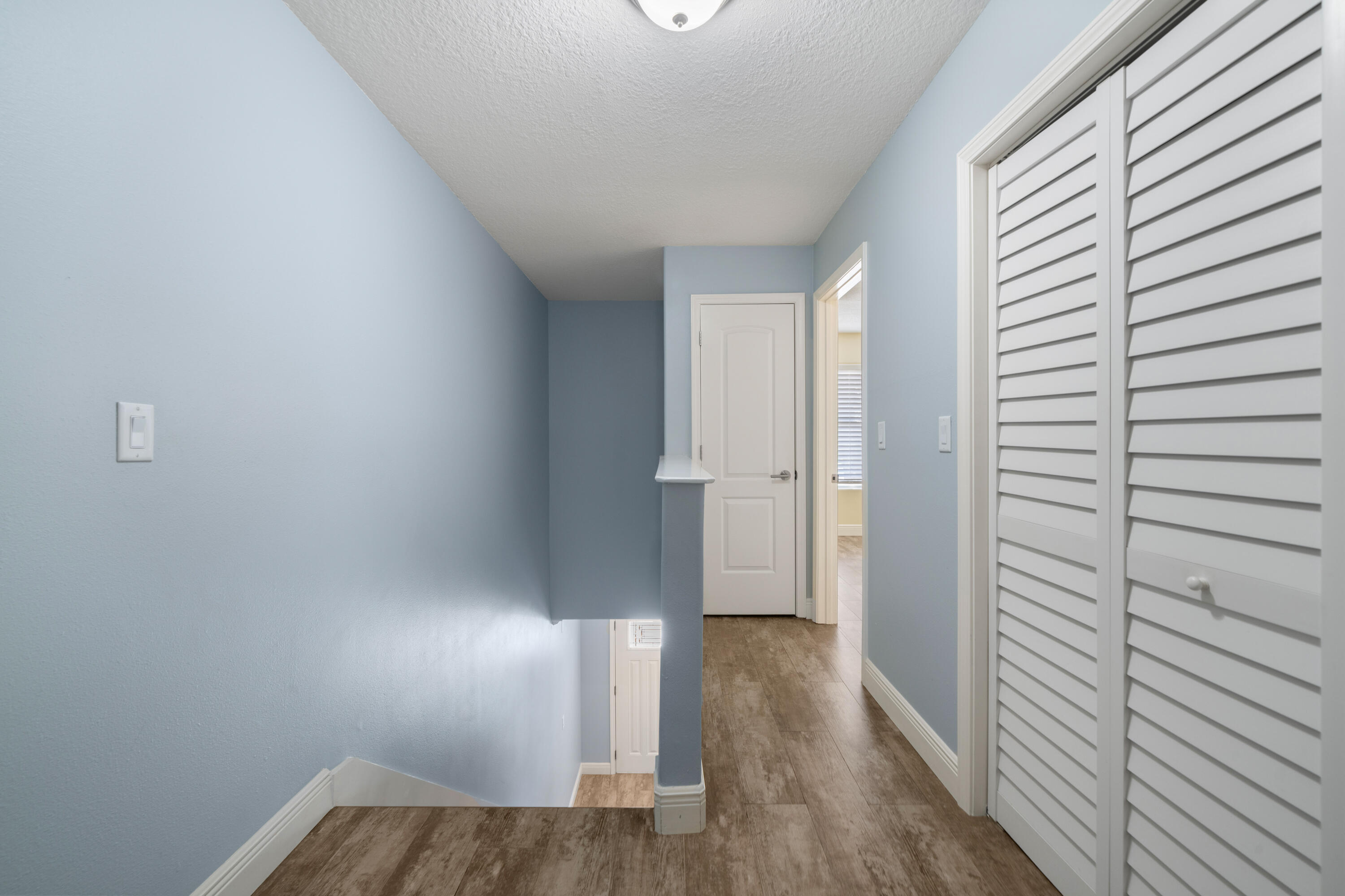 235 Pelican Place, Unit 3 Destin, FL 32541 - Photo 19 of 32 a view of hallway with wooden floor