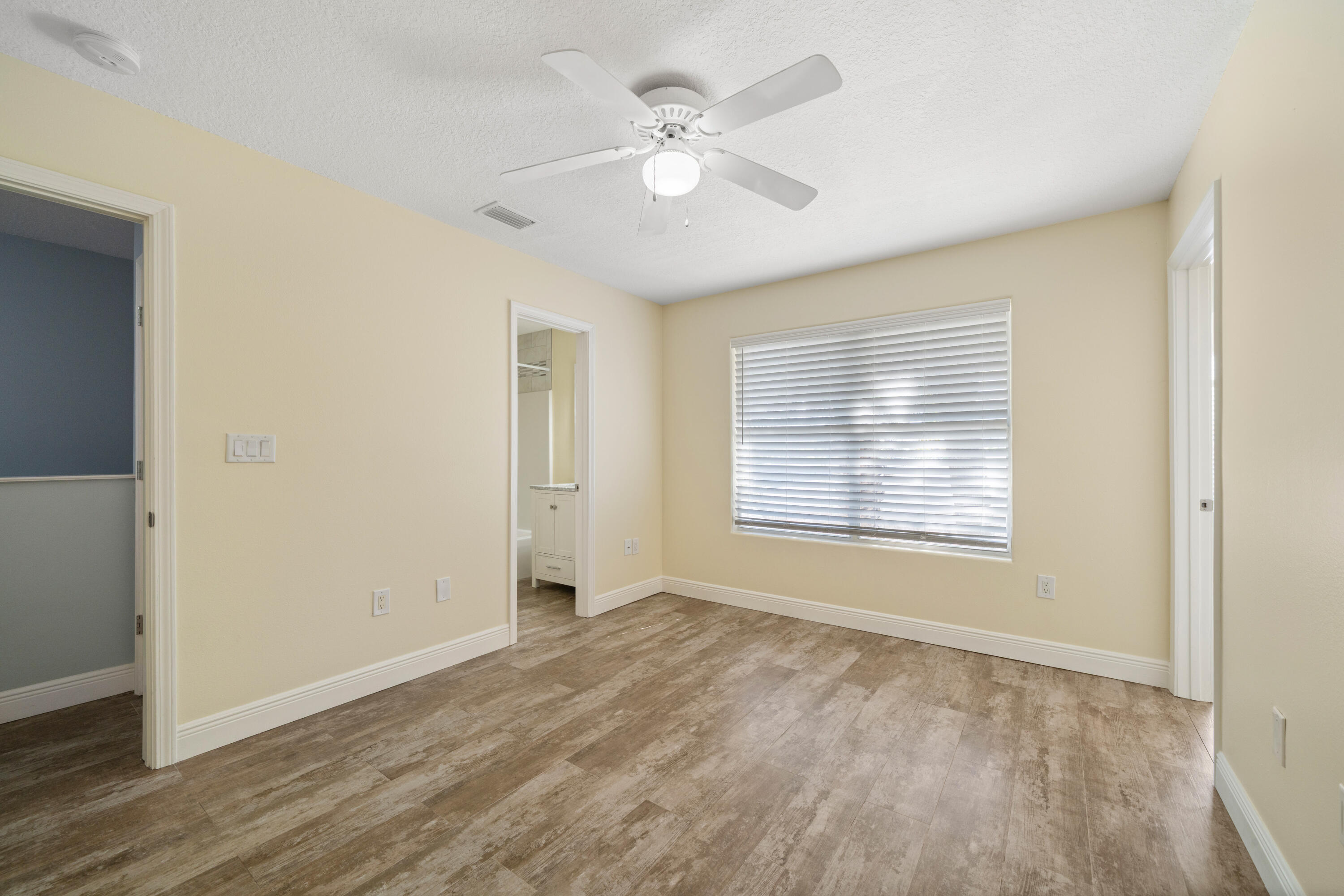 235 Pelican Place, Unit 3 Destin, FL 32541 - Photo 20 of 32 a view of an empty room with a window and a ceiling fan