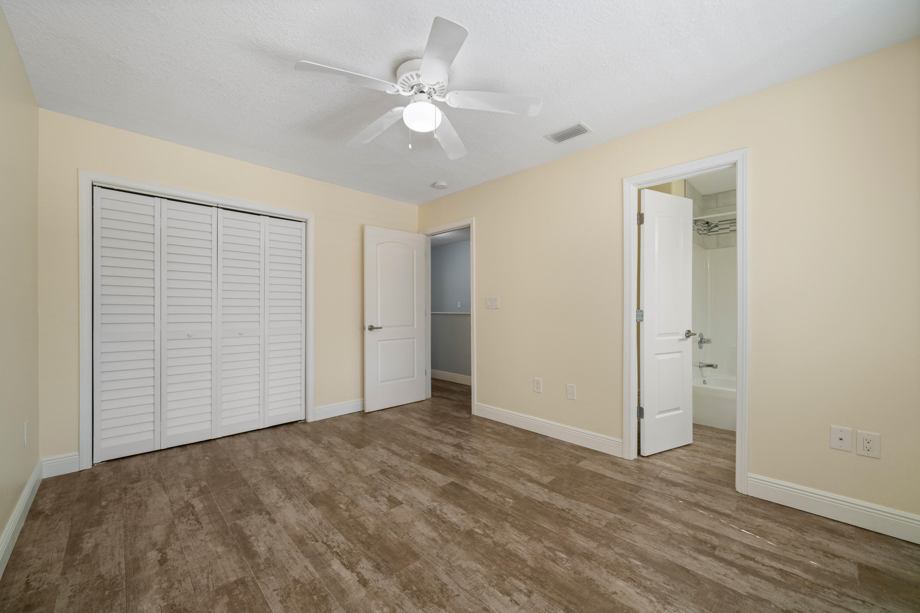 235 Pelican Place, Unit 3 Destin, FL 32541 - Photo 21 of 32 a view of an empty room with wooden floor