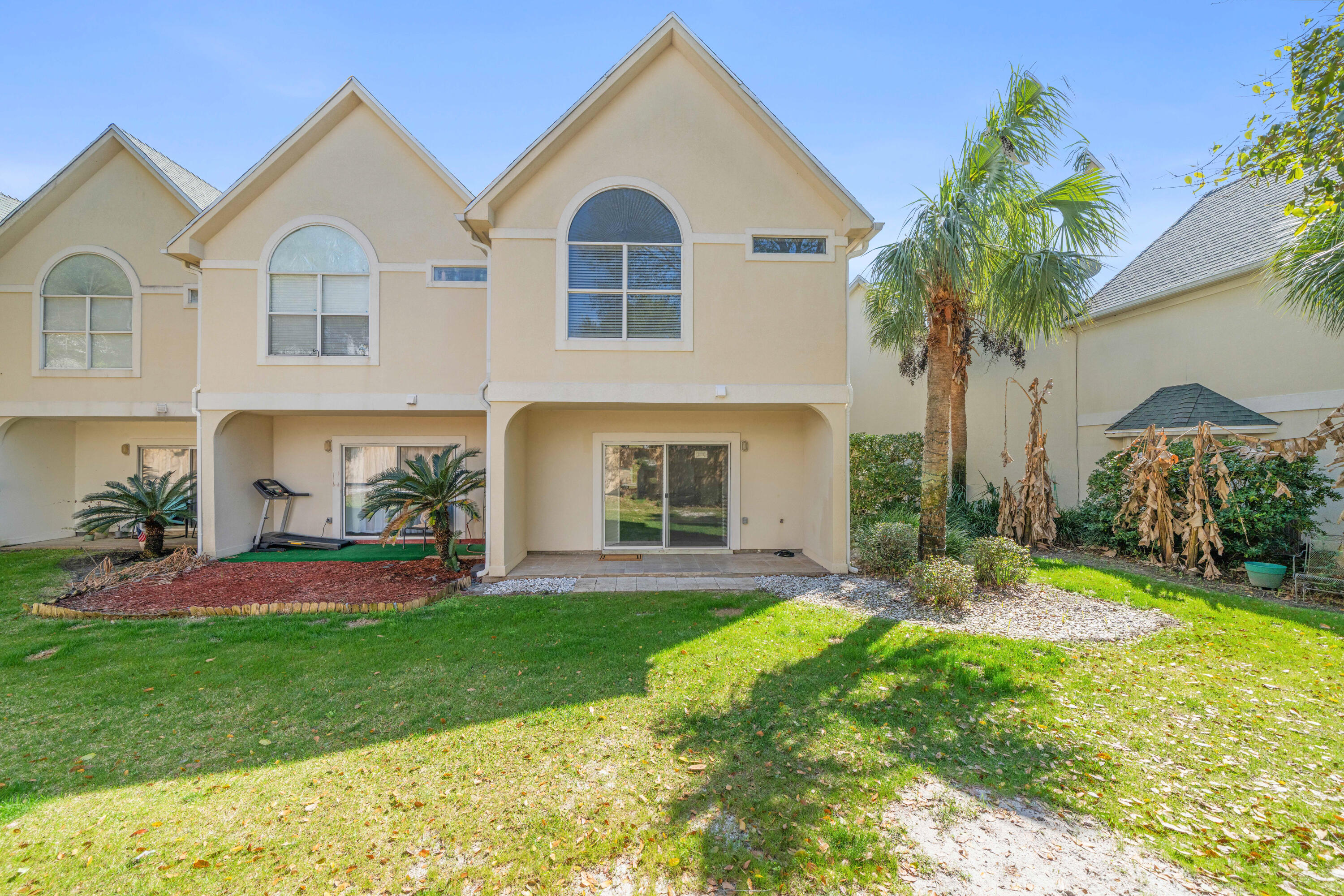 235 Pelican Place, Unit 3 Destin, FL 32541 - Photo 25 of 32 a front view of a house with a yard and garage