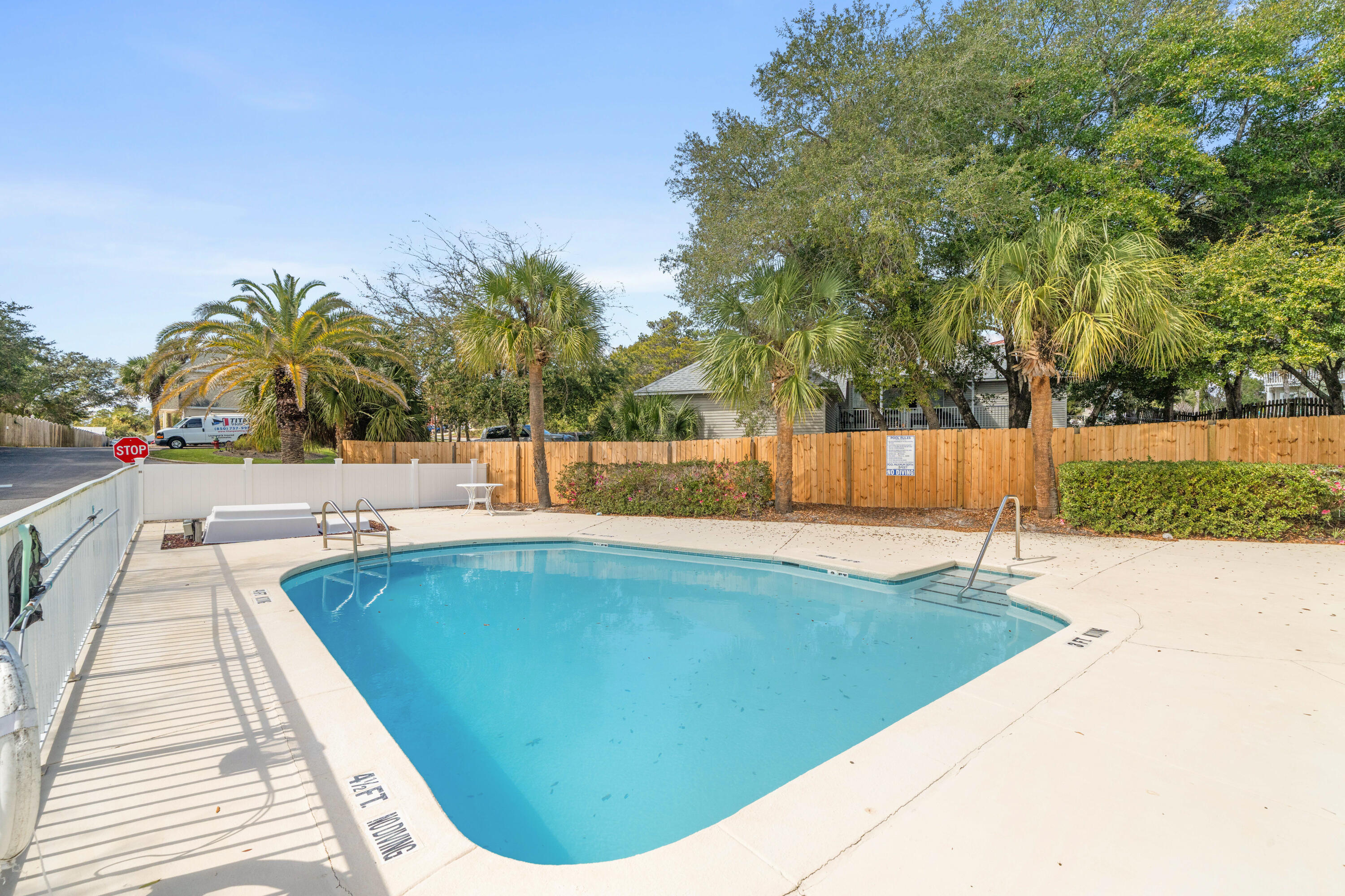 235 Pelican Place, Unit 3 Destin, FL 32541 - Photo 29 of 32 a view of a swimming pool and a yard