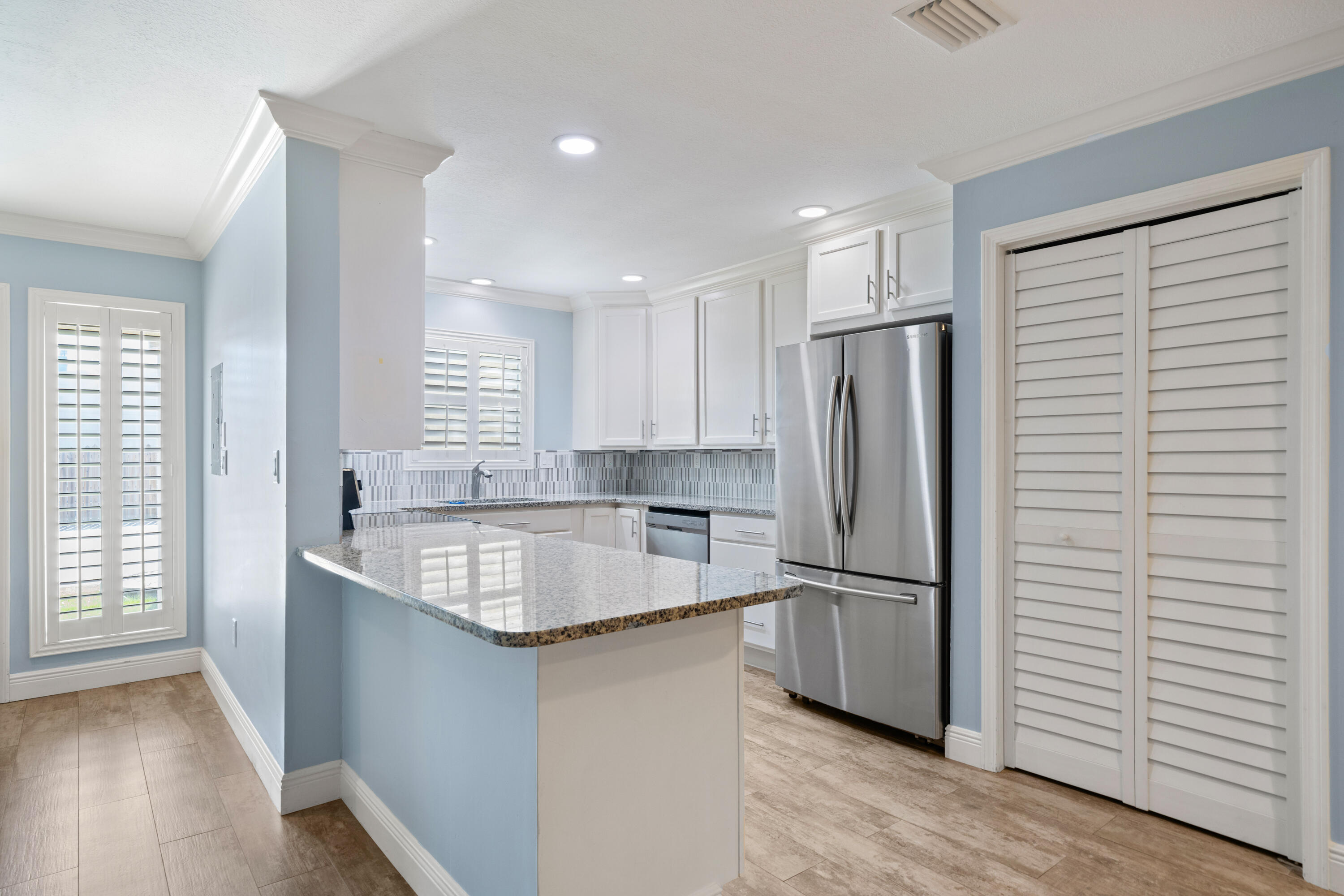 235 Pelican Place, Unit 3 Destin, FL 32541 - Photo 5 of 32 a kitchen with stainless steel appliances granite countertop a refrigerator a sink and a stove