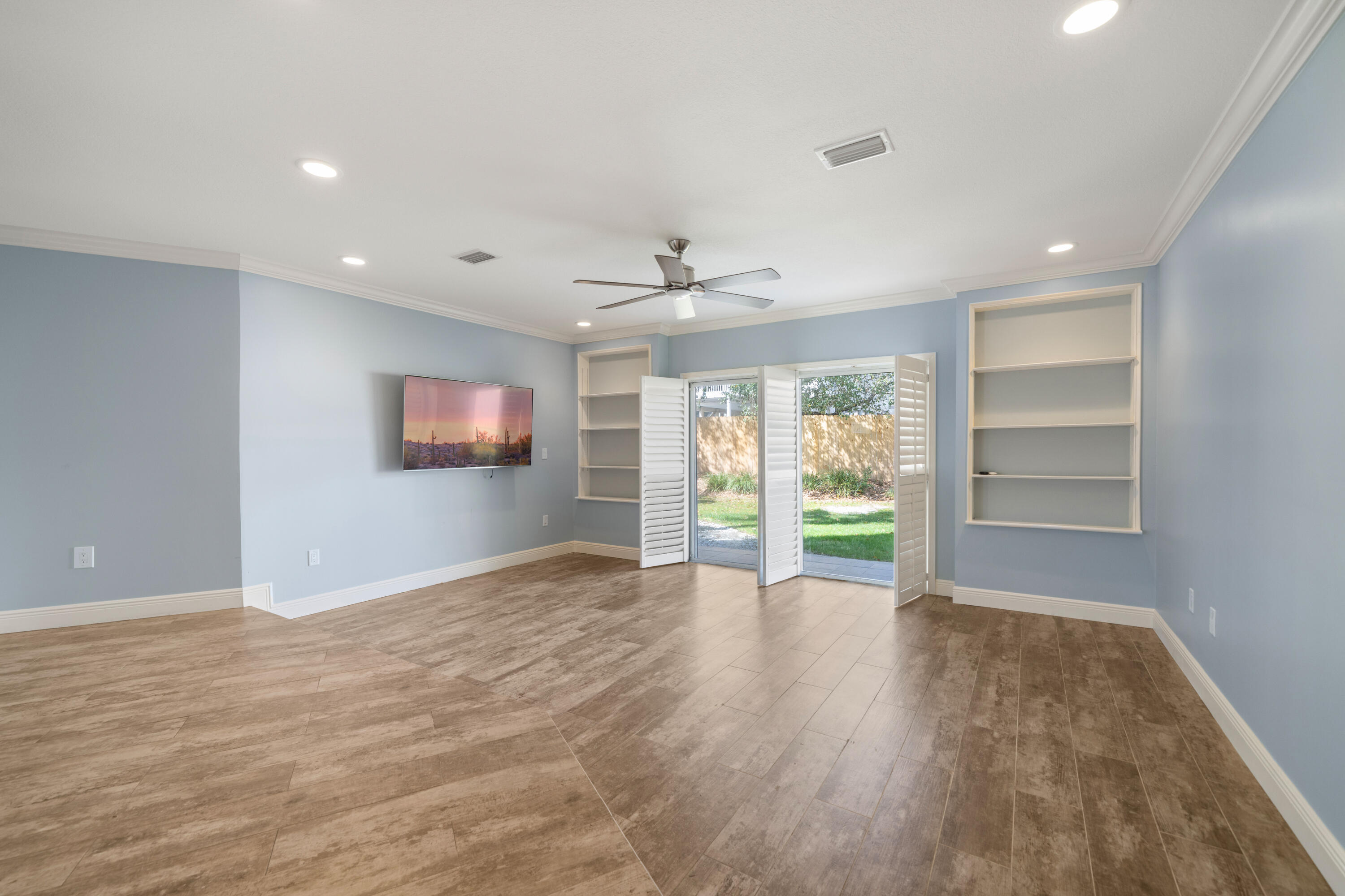235 Pelican Place, Unit 3 Destin, FL 32541 - Photo 7 of 32 a view of an empty room with a window and wooden floor