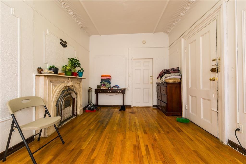 159 9th Street Brooklyn, NY 11215 - Photo 2 of 20 a view of a livingroom with furniture a fireplace wooden floor and windows