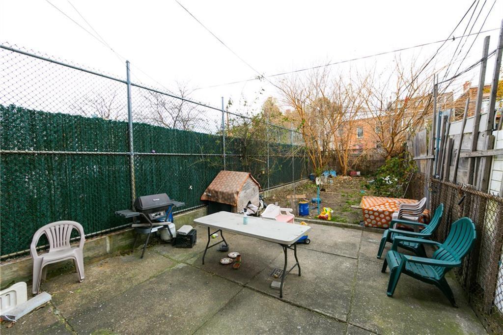 159 9th Street Brooklyn, NY 11215 - Photo 18 of 20 a backyard of a house with table and chairs