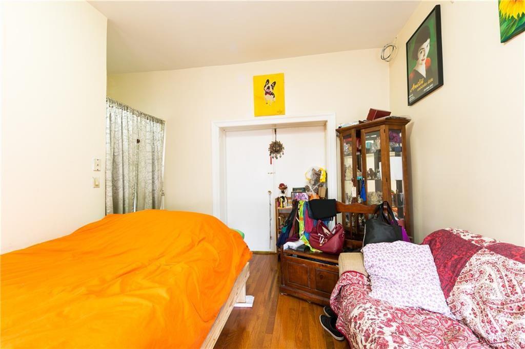 159 9th Street Brooklyn, NY 11215 - Photo 6 of 20 a bed room with a bed and a chair