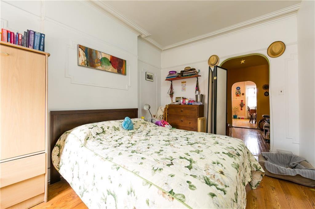 159 9th Street Brooklyn, NY 11215 - Photo 8 of 20 a bedroom with a bed and a dresser with wooden floor
