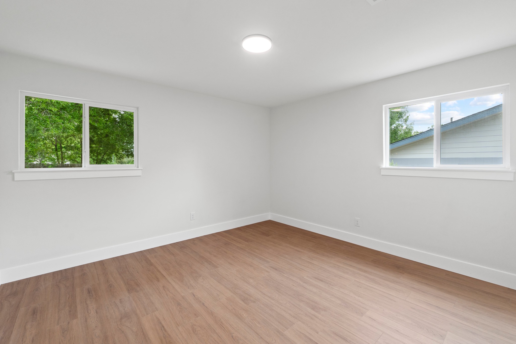 1608 Springer Lane Austin, TX 78758 - Photo 18 of 35 Bright interior space featuring light wood-finish flooring, white walls, and white baseboards