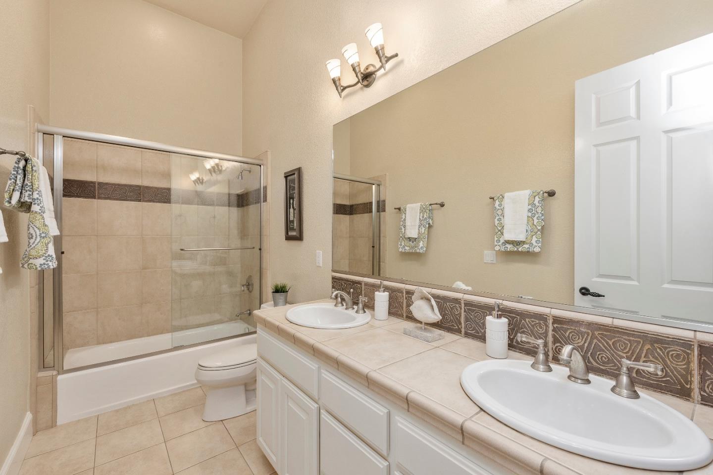 17682 Blanchard Drive Monte Sereno, CA 95030 - Photo 18 of 35 a bathroom with a granite countertop sink a toilet a mirror and shower