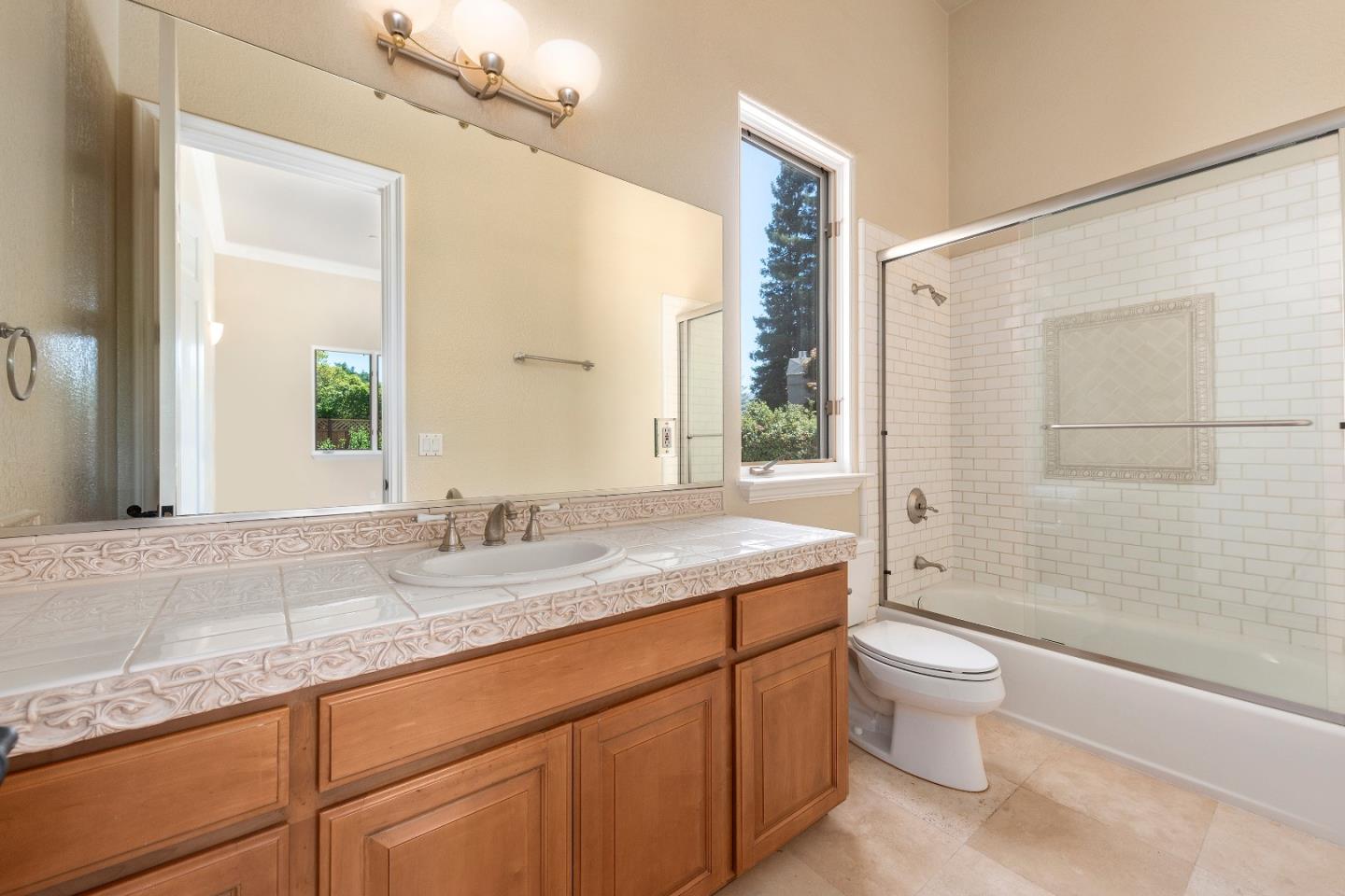 17682 Blanchard Drive Monte Sereno, CA 95030 - Photo 30 of 35 a bathroom with a granite countertop sink a toilet and shower