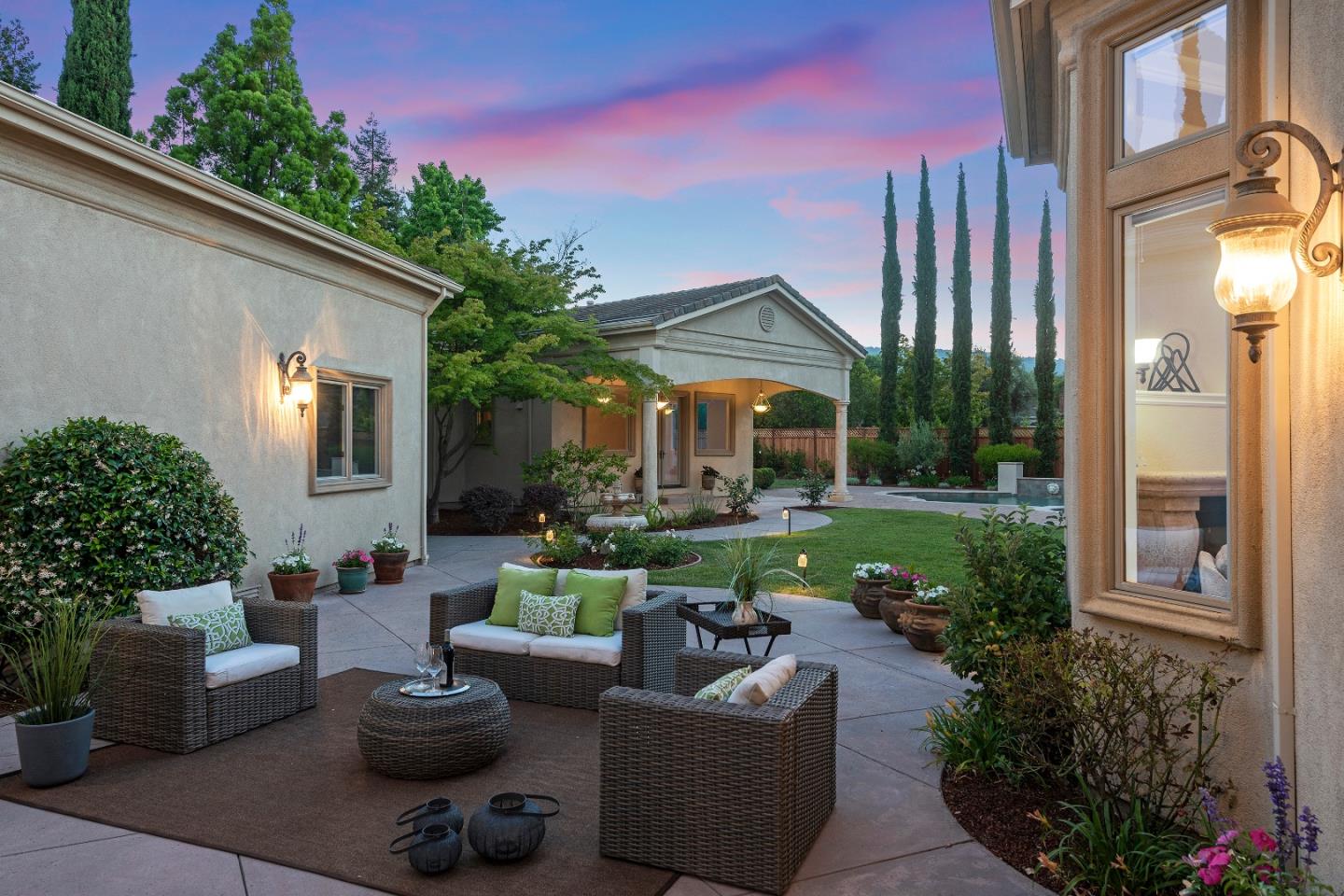 17682 Blanchard Drive Monte Sereno, CA 95030 - Photo 31 of 35 a view of a patio with couches table and chairs potted plants and a fountain