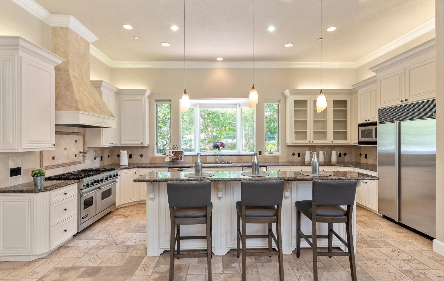17682 Blanchard Drive Monte Sereno, CA 95030 - Photo 9 of 35 a kitchen with stainless steel appliances granite countertop a stove top oven a sink refrigerator and cabinets