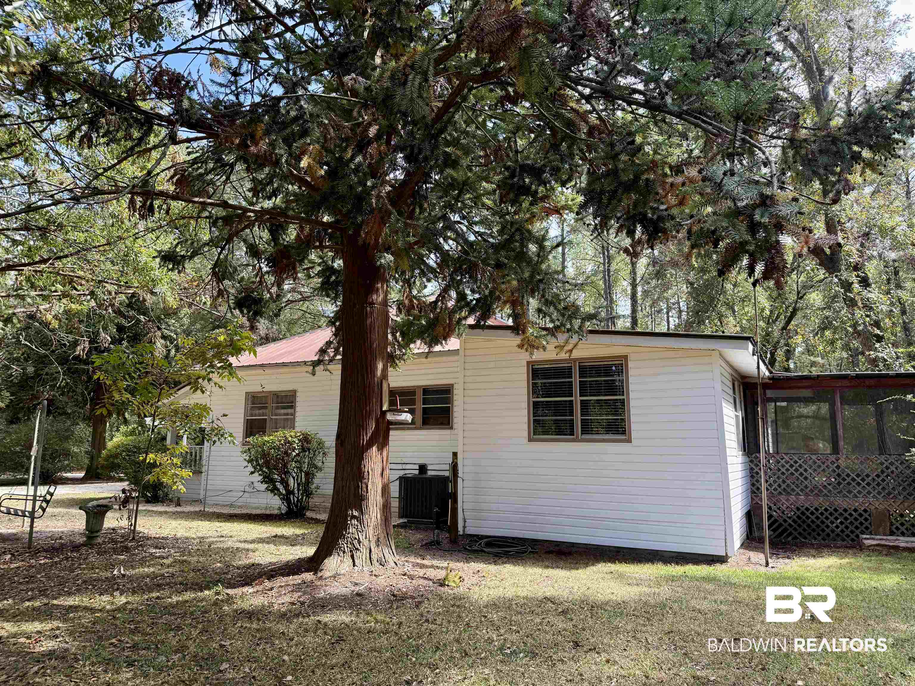 826 West Side Road Castleberry, AL 36432 - Photo 13 of 34 Rear view of house with a yard and a sunroom