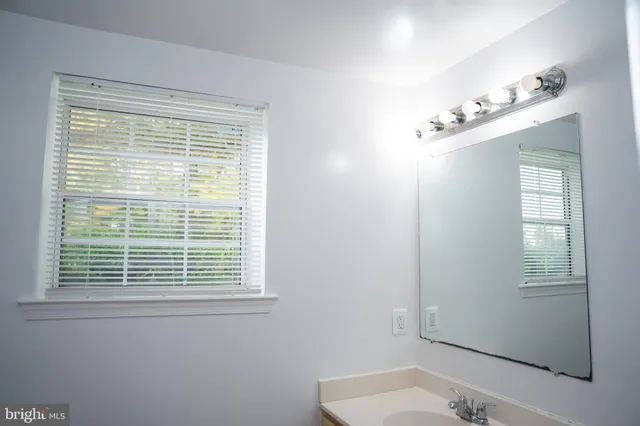 a view of wooden house with a small yard