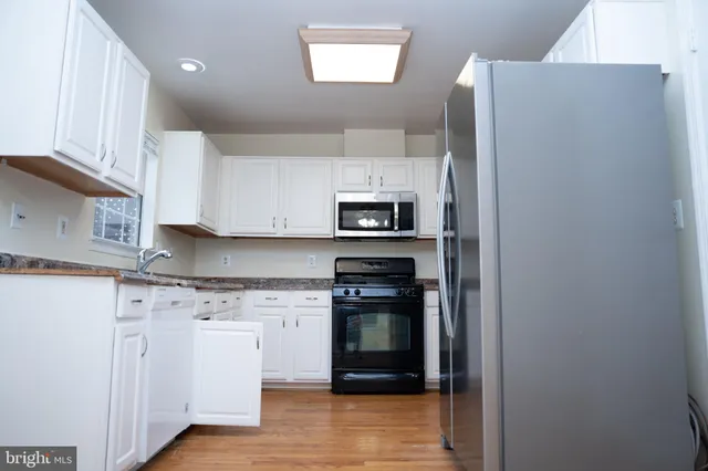 a kitchen with cabinets and stainless steel appliances