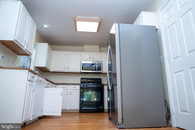 a kitchen with stainless steel appliances a refrigerator and a stove