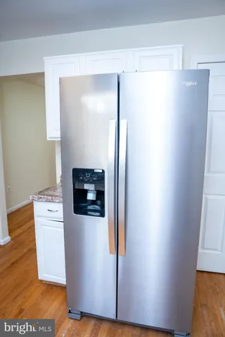 a utility room with wooden floor washer and dryer