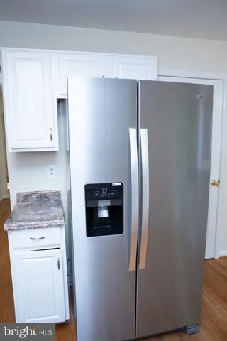 a kitchen with stainless steel appliances a refrigerator and cabinets