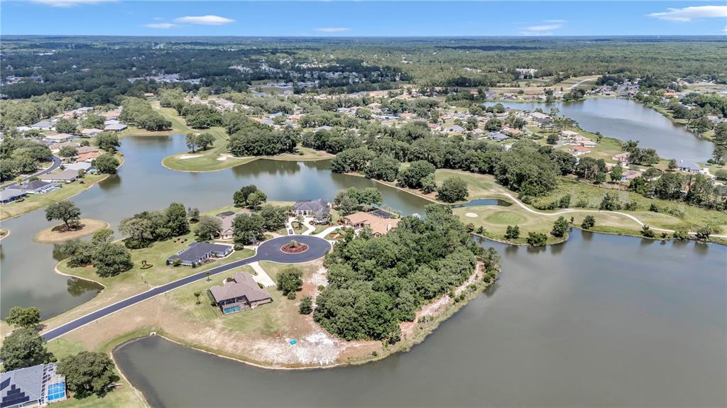 Diamond Island Avenue Ocala, FL 34472 - Photo 4 of 13 an aerial view of a house with a yard and lake view