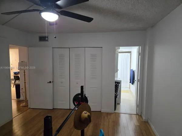 a view of a room with wooden floor