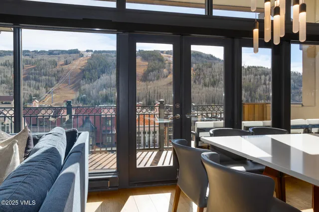 a living room with a large window and a table