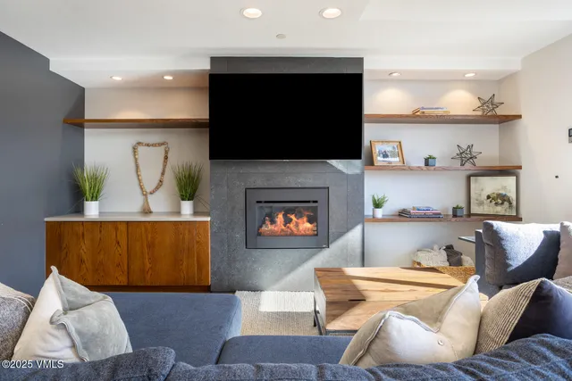 a living room with furniture and a fireplace