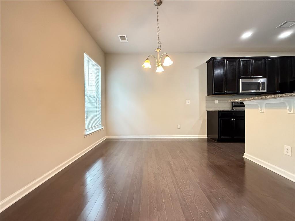 1739 Charcoal Ives Road Lawrenceville, GA 30045 - Photo 11 of 37 a view of kitchen with microwave a stove and wooden floor
