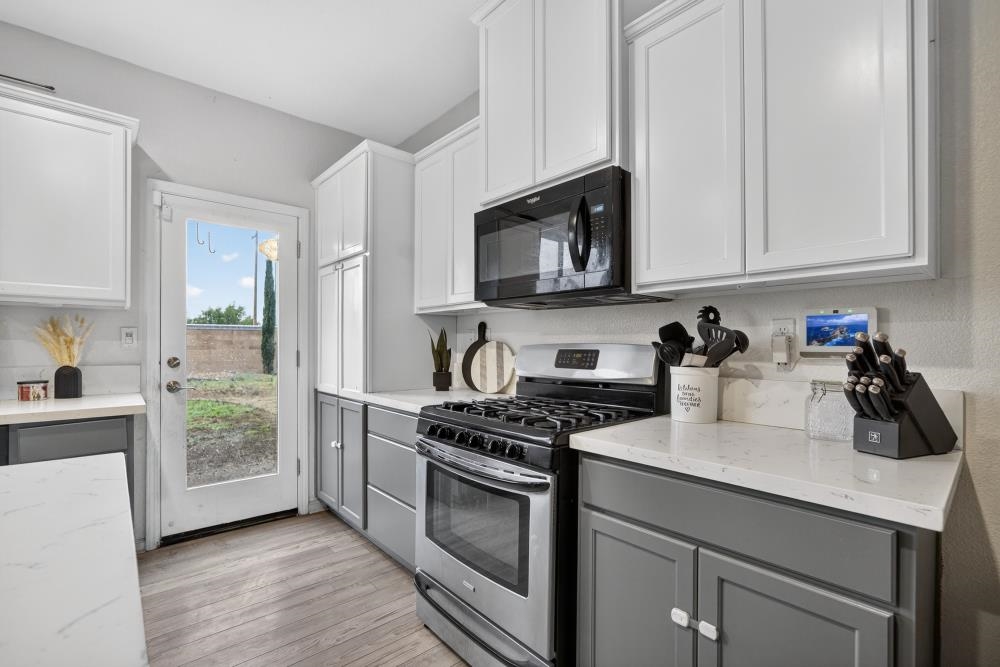 1958 Freedom Way Rio Vista, CA 94571 - Photo 12 of 44 a kitchen with granite countertop white cabinets and stainless steel appliances