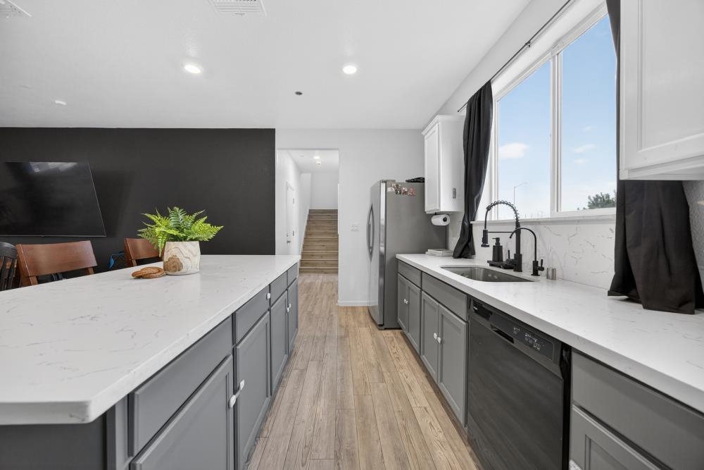 1958 Freedom Way Rio Vista, CA 94571 - Photo 13 of 44 a kitchen with kitchen island a sink appliances and cabinets