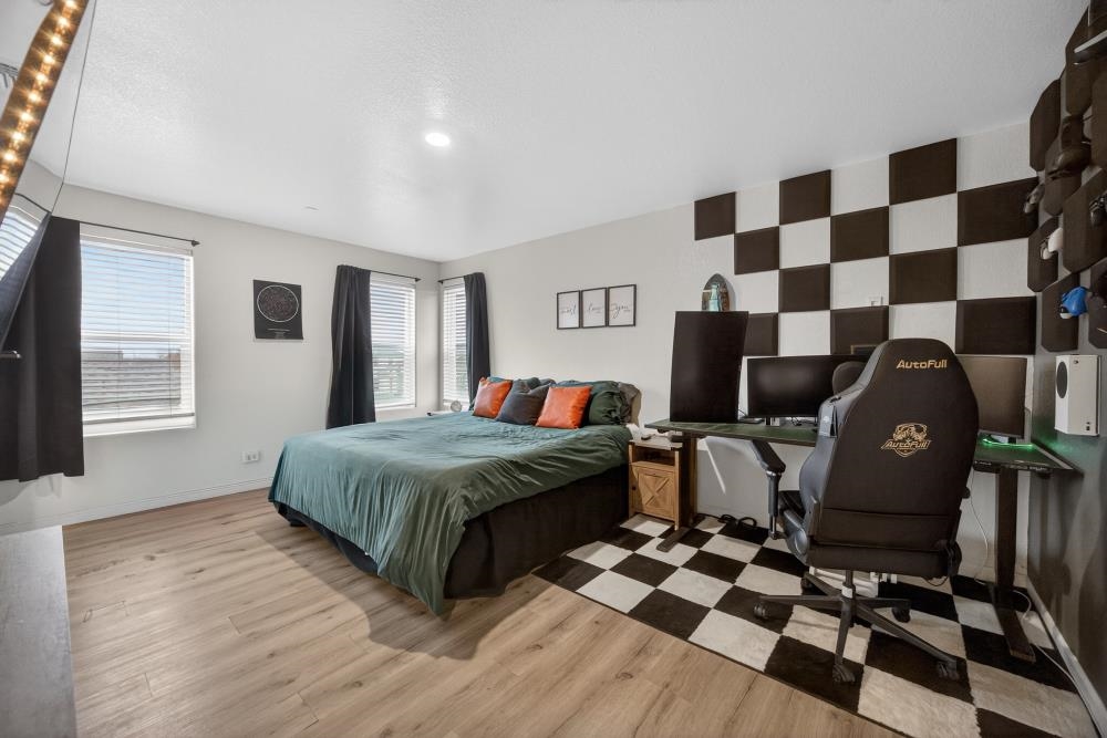 1958 Freedom Way Rio Vista, CA 94571 - Photo 24 of 44 a spacious bedroom with a bed and wooden floor