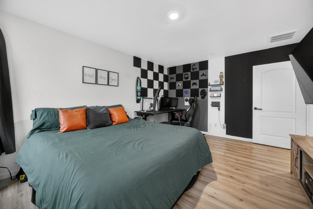 1958 Freedom Way Rio Vista, CA 94571 - Photo 26 of 44 a large bedroom with a bed and wooden floor