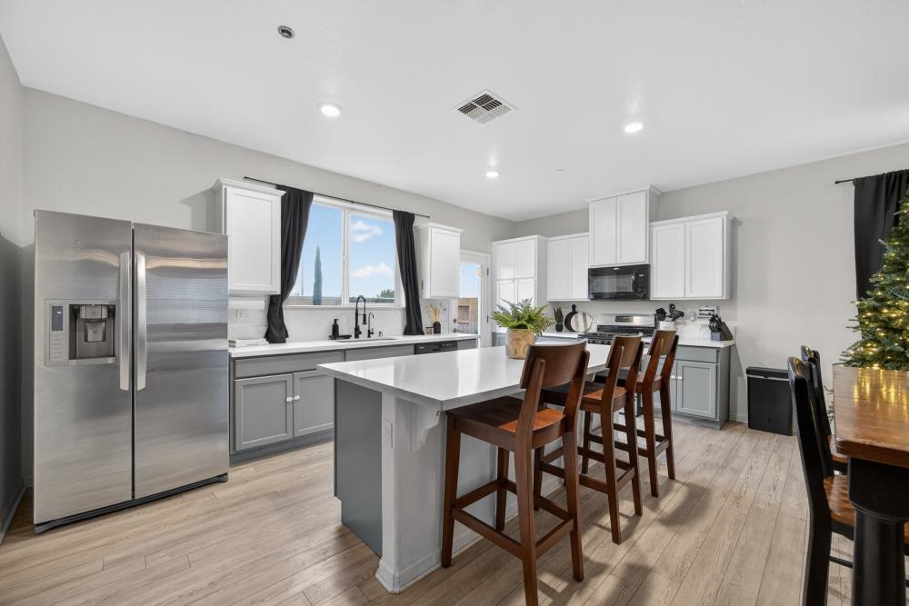 1958 Freedom Way Rio Vista, CA 94571 - Photo 9 of 44 a kitchen with refrigerator a sink and chairs