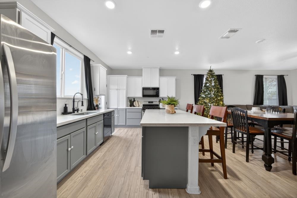 1958 Freedom Way Rio Vista, CA 94571 - Photo 10 of 44 a kitchen with kitchen island granite countertop wooden floors and stainless steel appliances