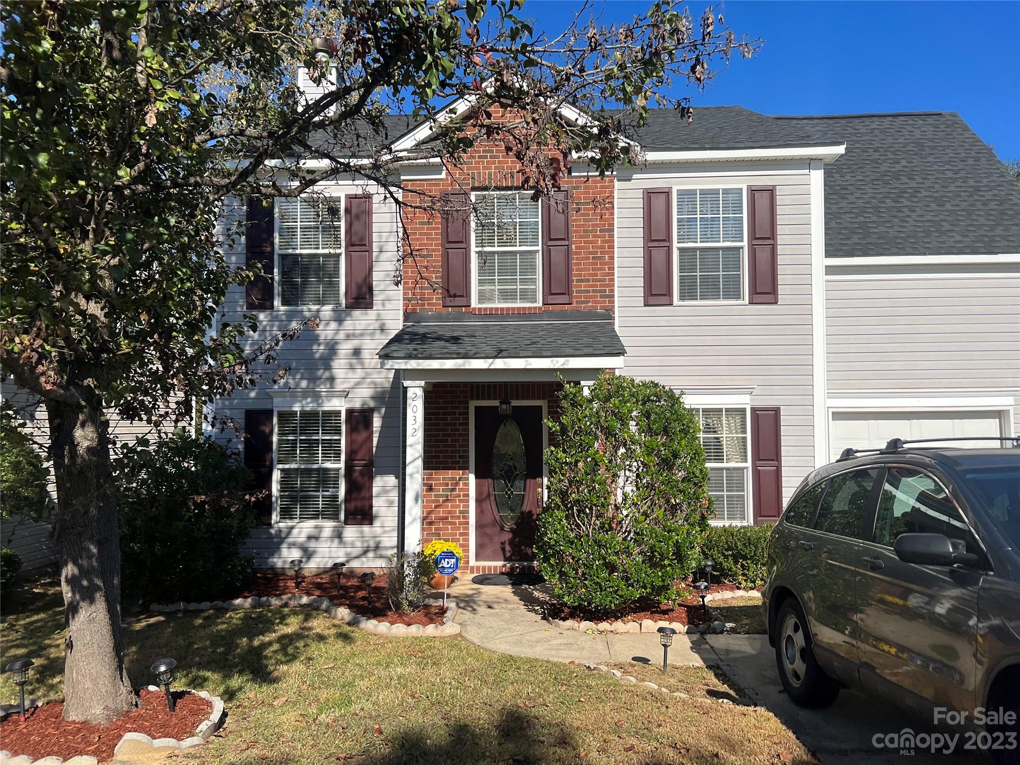a front view of a house with yard