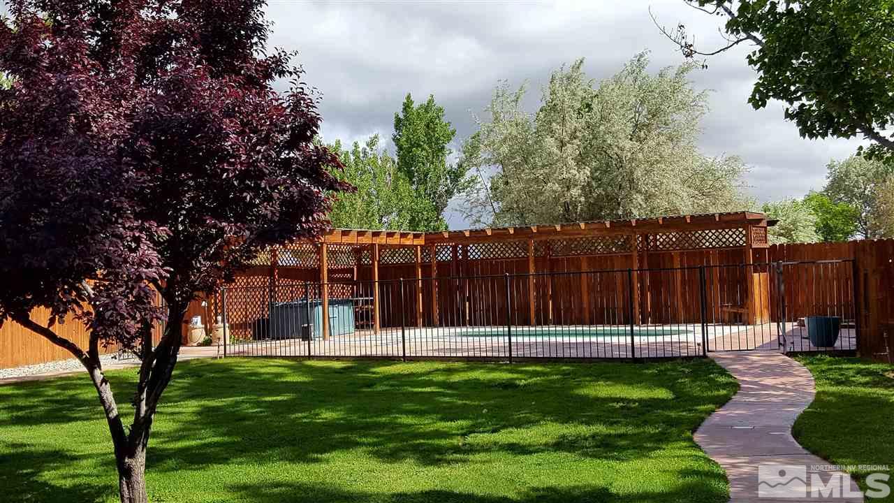 2170 Soda Lake Road Fallon, NV 89406 - Photo 20 of 25 a view of a backyard with large trees and wooden fence