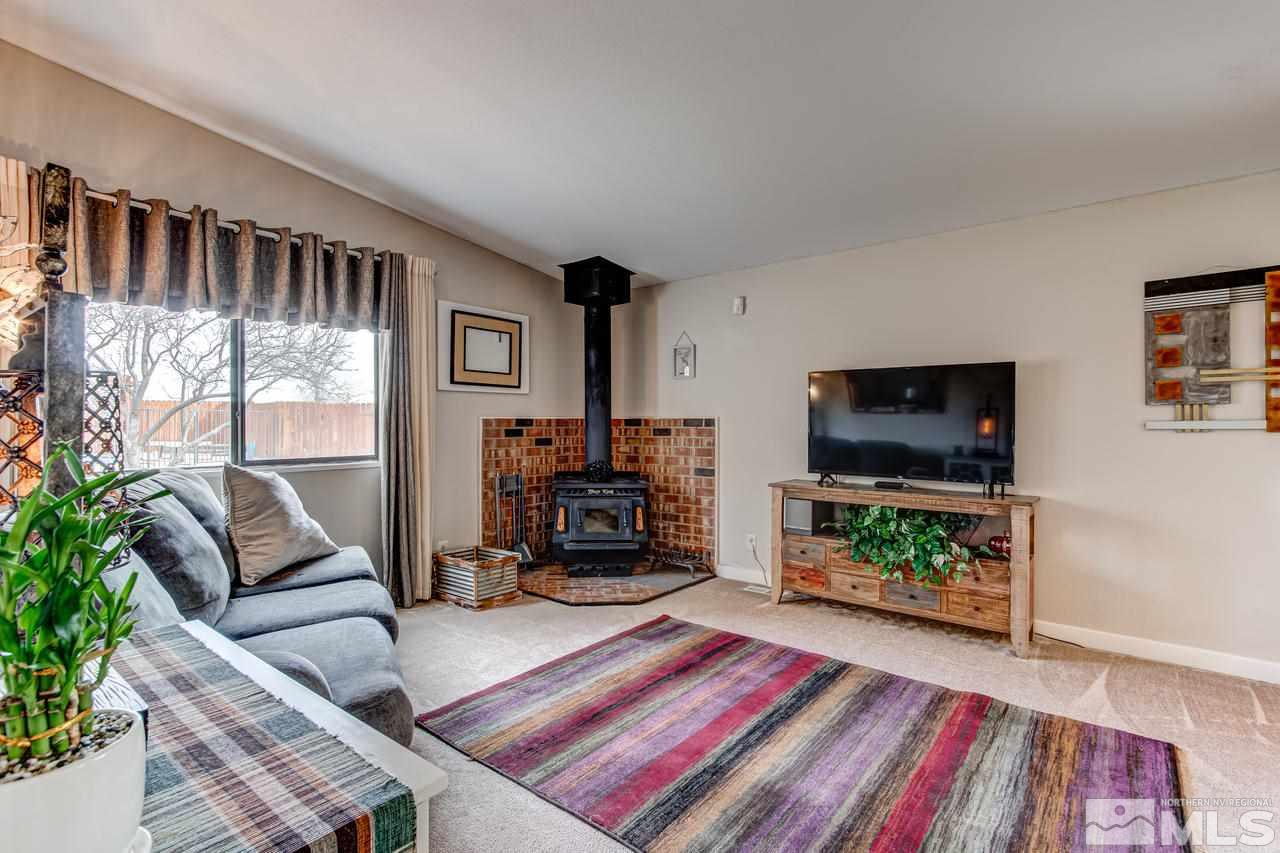 2170 Soda Lake Road Fallon, NV 89406 - Photo 10 of 25 a living room with furniture a flat screen tv and a fireplace