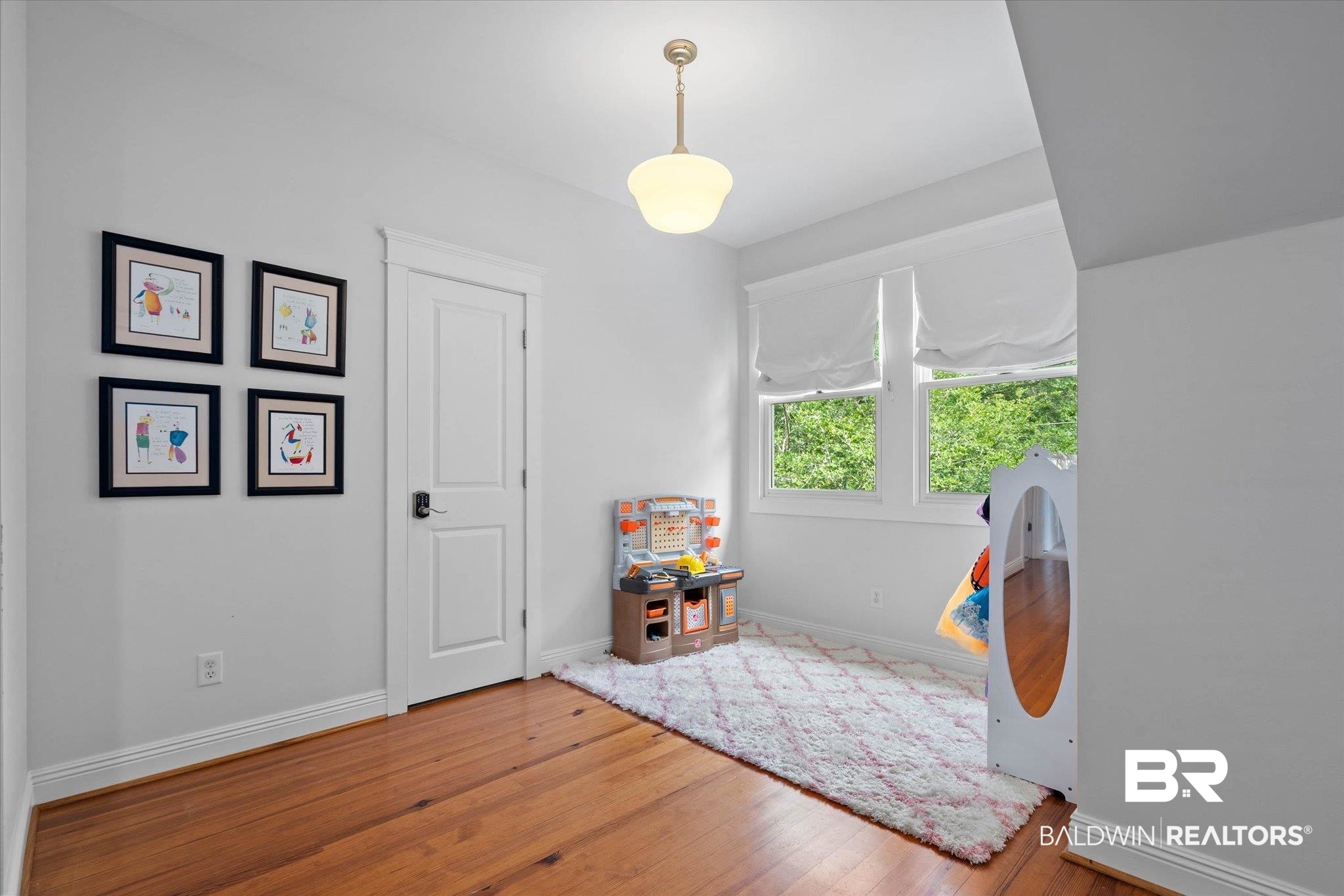 3813 Austill Lane Mobile, AL 36608 - Photo 15 of 37 Bright interior space featuring wood-finish flooring, white trim, and a white paneled door