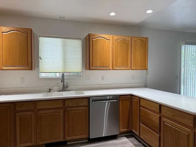 a kitchen with a sink and a window