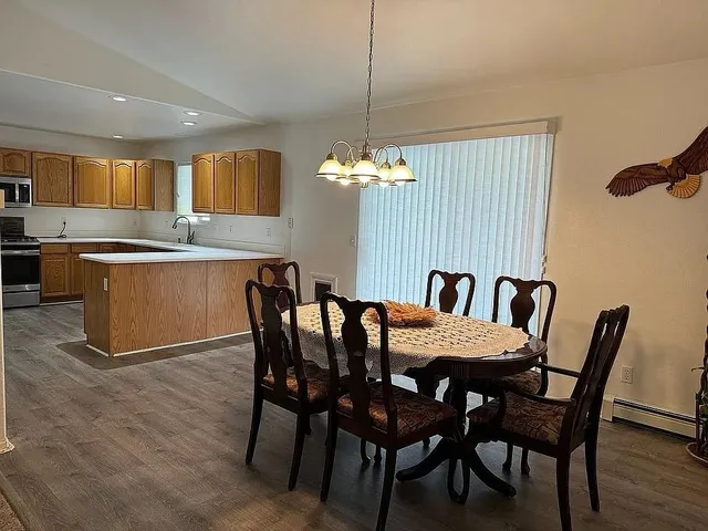 a dining room with furniture and window