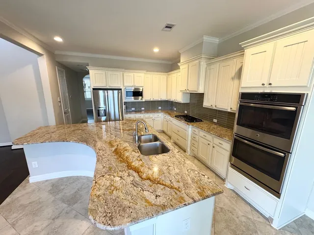 a kitchen with a stove a sink and a microwave