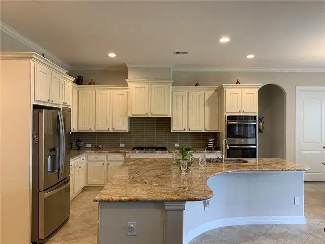 a kitchen with stainless steel appliances granite countertop a refrigerator sink and cabinets