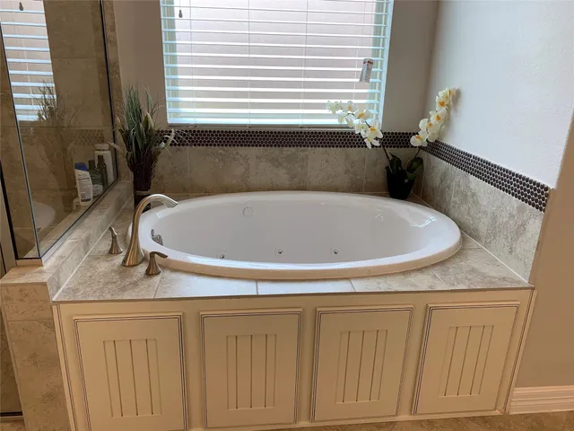 a large bathroom with a granite countertop sink mirror and shower