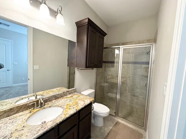a view of a hallway with a chandelier fan and windows