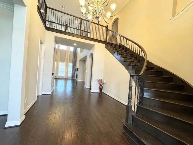 a view of entryway and hall with wooden floor