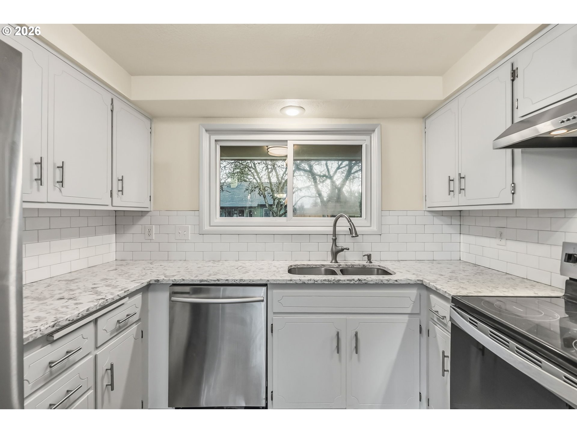 446 Kodiak Street Eugene, OR 97401 - Photo 12 of 34 a kitchen with granite countertop white cabinets white appliances and a sink