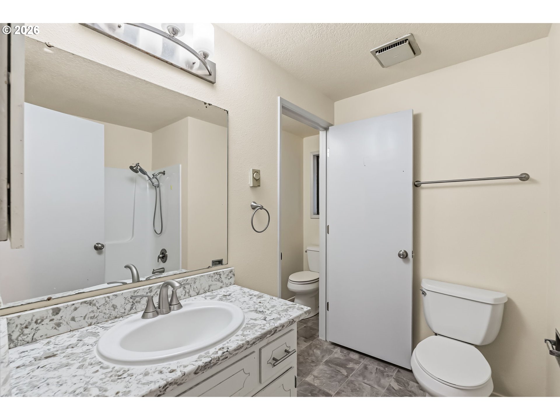 446 Kodiak Street Eugene, OR 97401 - Photo 20 of 34 a bathroom with a granite countertop sink toilet a mirror and shower