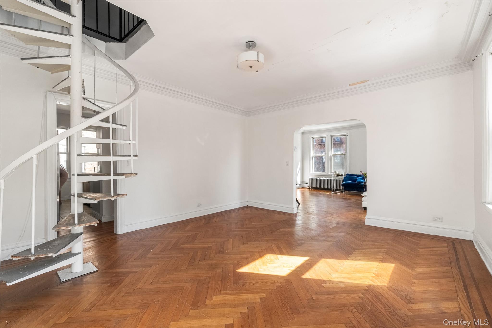 2969 Perry Avenue Bronx, NY 10458 - Photo 11 of 36 a view of empty room with wooden floor and fan