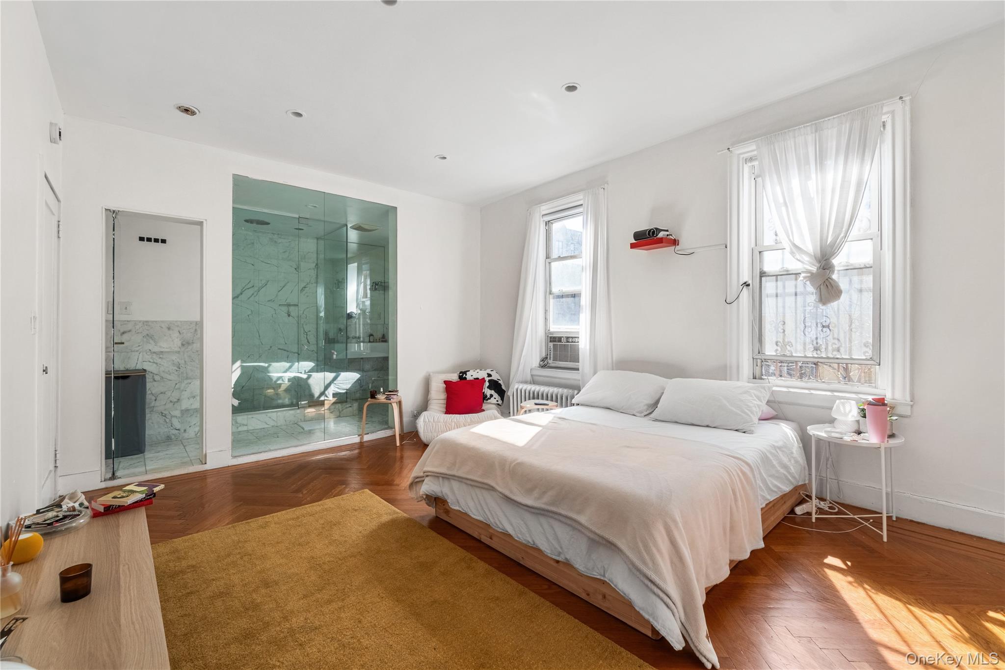 2969 Perry Avenue Bronx, NY 10458 - Photo 12 of 36 a bedroom with a bed and wooden floor