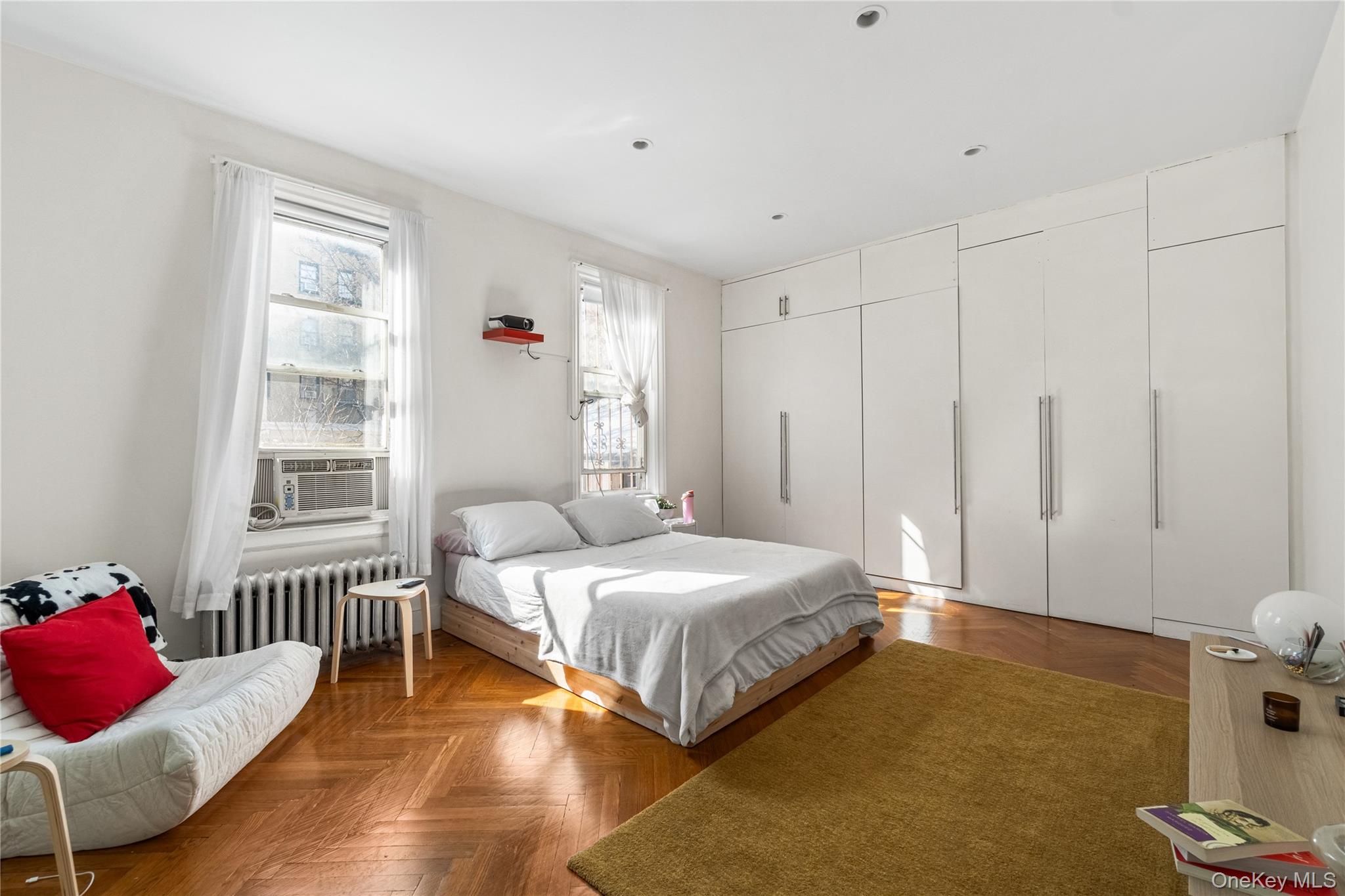 2969 Perry Avenue Bronx, NY 10458 - Photo 13 of 36 a bedroom with a bed and wooden floor